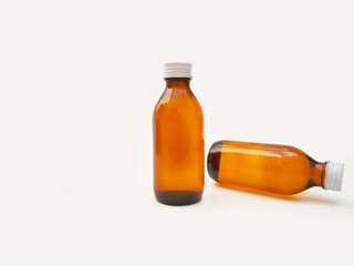 Amber glass bottles with an aluminum cap isolated on a white background, 2 brown glass bottles for...