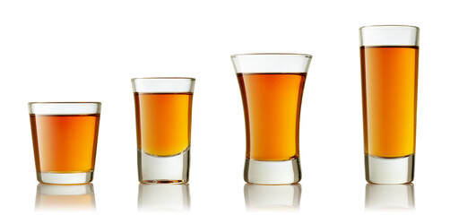 set of shot glasses with tequila or liqueur isolated on white background