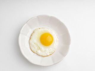 Sunny side up egg on white plate, isolated