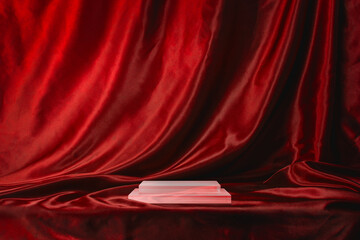 赤いシルクの布で覆われたアクリル製の商品台。ステージ