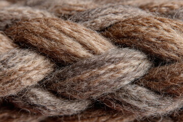Twisted strands of fiber form a dense, tactile surface ideal for handmade aesthetics, knitting content, or textile design themes with a natural, warm appeal.


