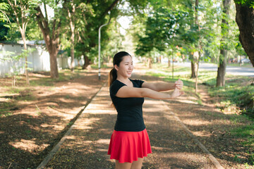 Asian women are stretching their muscles before going out to run to the park to keep themselves...