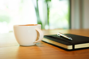 Barista skillfully pouring steamed milk into a cup of espresso, creating latte art in a cozy café during a busy morning.