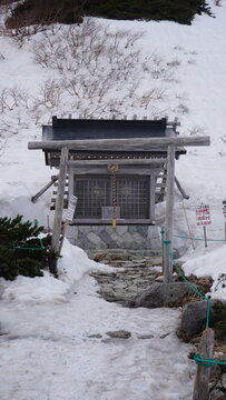 Small wooden shrine in snowy Japanese mountain landscape - Shinshukomagatake Shrine