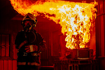 firefighters wearing fire fighter suit for safety and using twirl water extinguisher for fighting the fire flame in emergency situation.. - Safety Firefighter and industrial concept.