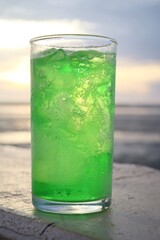 Green soft drink and ice cubes