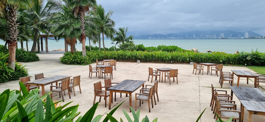 Outdoor Dining Area at Tropical Resort. Ocean View for Relaxation.