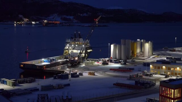Mobile crane unloads containers from the offshore supply vessel Troms Arcturus at Vestbase in Norway