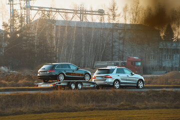Car recovery service moving vehicle on trailer