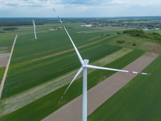 Large wind turbine surrounded by farmland
