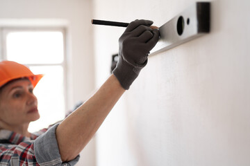 home improvement and repair concept. Construction, builder and contractor with level measuring. handyman in hardhat holding spirit level