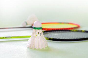Badminton sport equipments, rackets and shuttlecocks, on badminton floor of indoor court, soft...