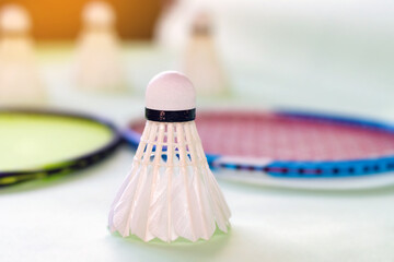 Badminton sport equipments, rackets and shuttlecocks, on badminton floor of indoor court, soft...