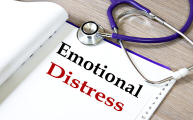 EMOTIONAL DISTRESS - words on a white sheet against the background of a stethoscope