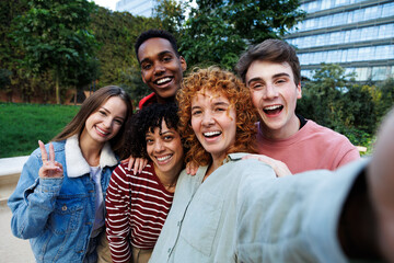 Happy students taking a selfie outside university campus