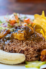 Caribbean culinary scene with rice, beans, succulent shrimp, crispy plantains and vibrant salad