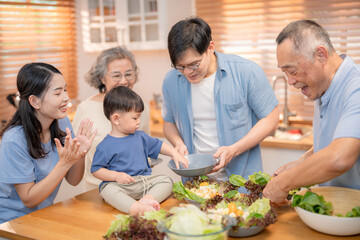 Family cooking together in a bright kitchen while preparing a healthy meal with fresh vegetables and laughter