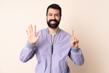 Fototapeta premium Caucasian man with beard wearing a jacket over isolated background counting six with fingers