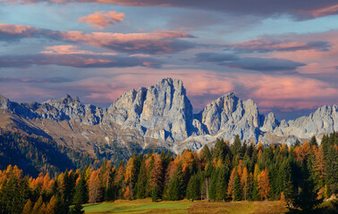 a splendid sunset on the Belluno Dolomites surrounded by the colours of Autumn