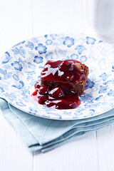 Chocolate brownie with cherry syrup . Selective focus. Copy space.	