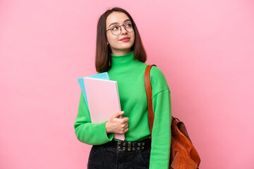 Young student Ukrainian woman isolated on pink background thinking an idea while looking up