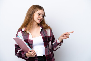 Teenager student Russian girl isolated on white background pointing finger to the side and...