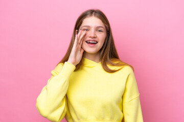 Teenager Russian girl isolated on pink background shouting with mouth wide open