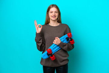 Teenager Russian girl isolated on blue background with a skate and doing OK sign