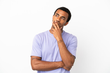 African American handsome man on isolated white background having doubts while looking up
