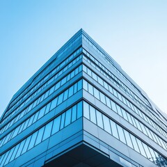 Modern glass skyscraper against a clear blue sky