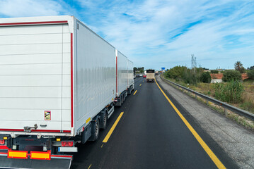 Highway scene with a megatrailer (gigaliner) truck carrying three specialized swap bodies for parcel and groupage logistics.