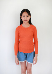 Portrait of Asian girl child age 10-11 years old standing on white studio background.