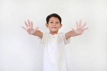 Portrait of Asian little boy kid show both five fingers or bye and looking straight camera while standing on white background. Focus at face.