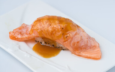 Salmon Nigiri Sushi with Sweet Soy Sauce on White Plate