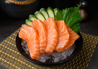 Fresh Salmon Sashimi Slices on Ice with Cucumber Garnish