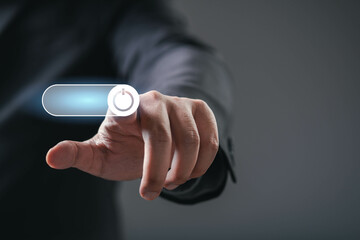 A hand reaching toward a digital power button, symbolizing control or activation in a modern, technology-driven context.
