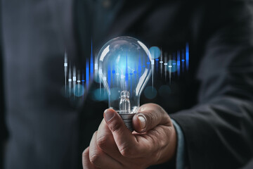 A hand holding a light bulb with sound wave graphics, symbolizing innovation, ideas, and technology in a modern context.