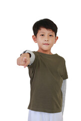 Portrait of Asian boy age 7 years old pointing at camera or you while standing isolated on white background.