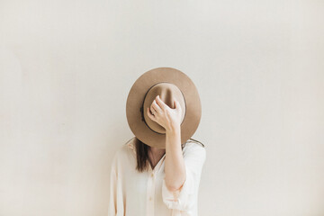 Stylish Woman Wearing Hat in Minimalist Setting