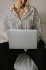 Casual Remote Work Scene. Relaxed Woman with Laptop in Cozy Living Space, Simple and Comfortable Style
