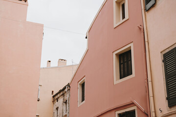 Urban Architecture with Pink Walls and Shutters