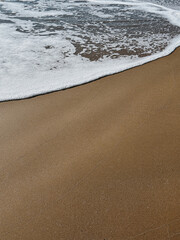 Gentle Waves Lapping on Sandy Beach