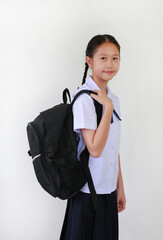 Portrait Asian student girl in school uniform with carrying backpack bag on white studio background. Schoolgirl back to school concept.