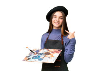 Young artist man holding a palette over isolated chroma key background giving a thumbs up gesture