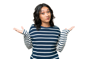 Young Argentinian woman over isolated background having doubts while raising hands