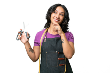 Young seamstress argentinian woman over isolated background thinking an idea while looking up