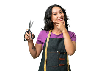Young seamstress argentinian woman over isolated background happy and smiling
