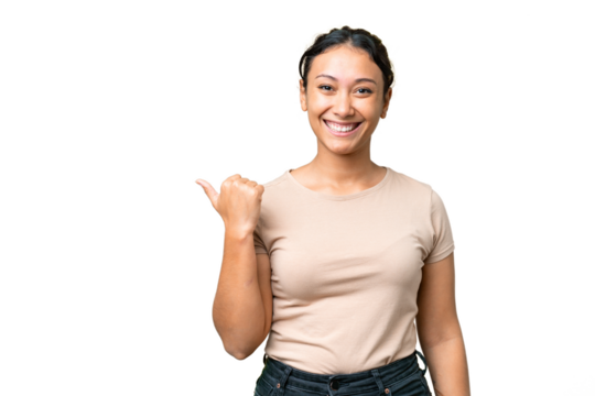 Young Uruguayan woman over isolated chroma key background pointing to the side to present a product