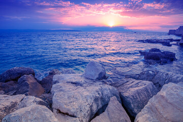 Seascape during sunset. Rocky seashore near Akko city in the evening, Israel. Sunset over the sea