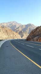Colorful mountains highlight unique geology, mountains framing paved highway, popular tourist destination , encouraging adventure travel, memorable adventure awaits. Road in mountains 